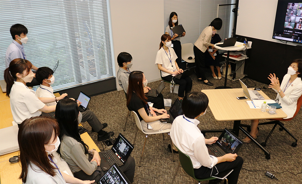 The president and employees engaging at the meeting.